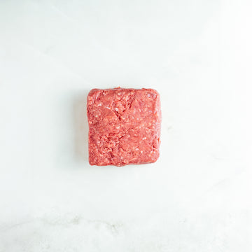 Block of ground meat on a white background