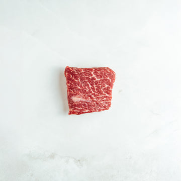 Raw bavette on a white marble surface