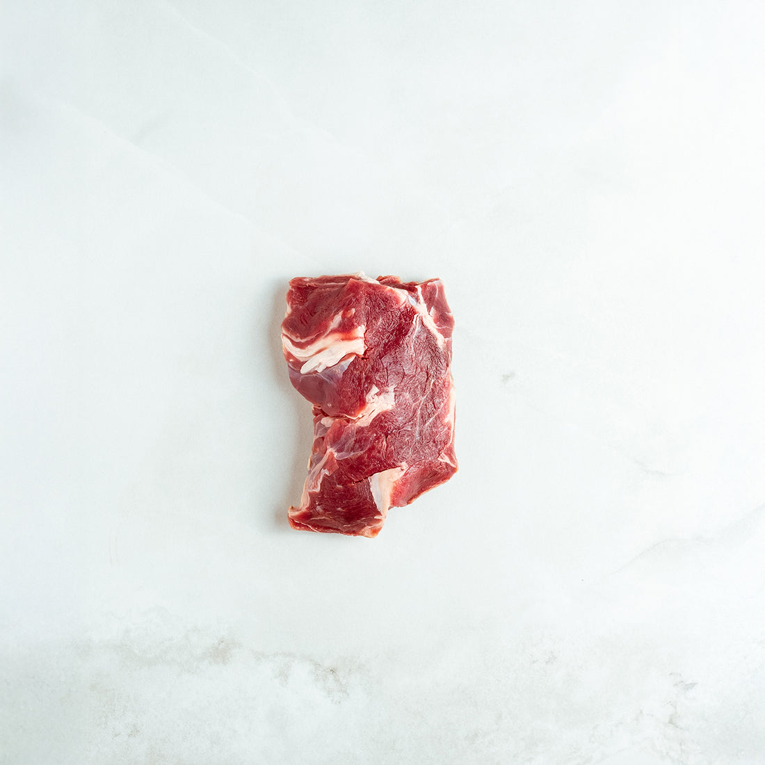 Raw chuckeye steak on a white background