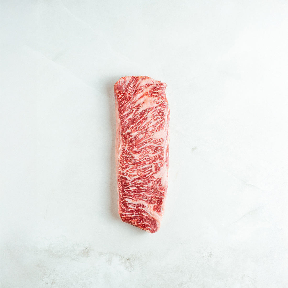 Raw denver steak on a white background